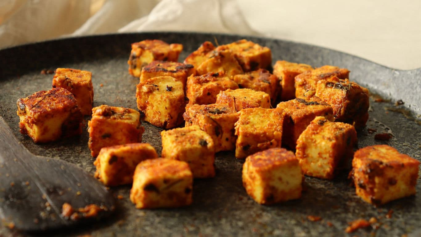 Spiced tofu cubes on a skillet