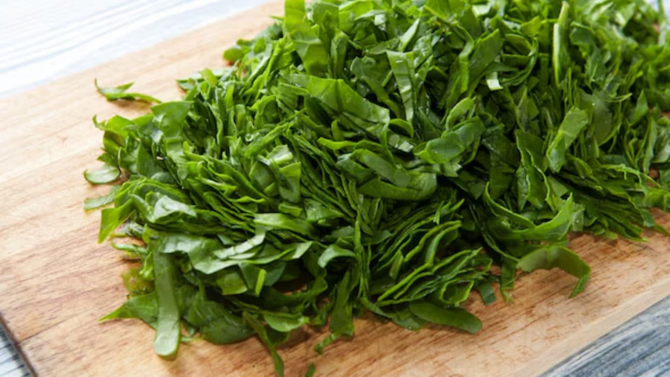 Freshly Chopped Spinach on Wooden Board