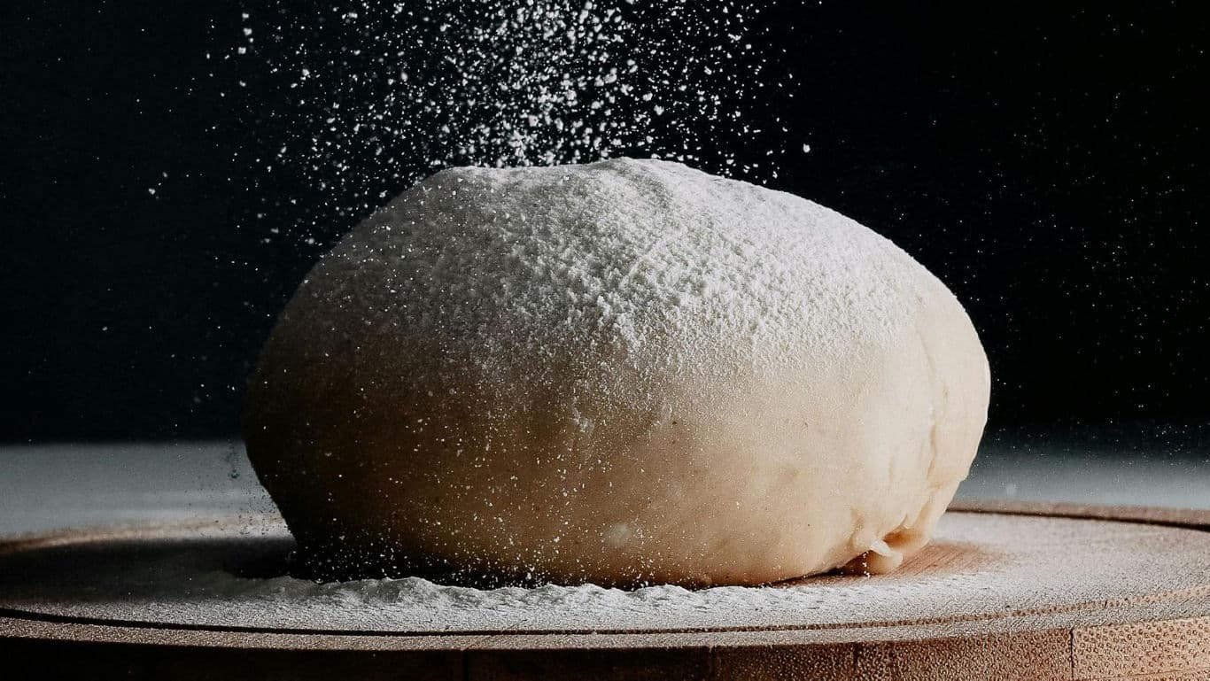 Fresh dough with flour dusting