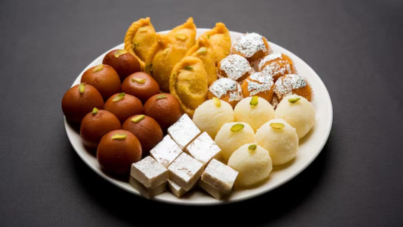 Assorted Indian sweets on white plate