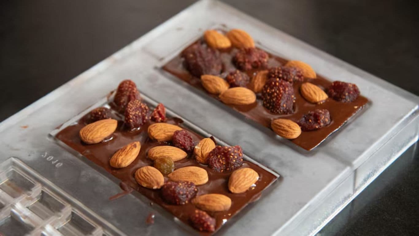Handcrafted chocolate bars with almonds and berries