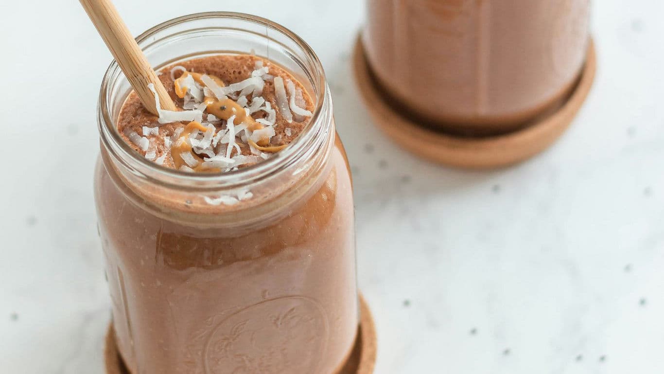 Chocolate smoothie with coconut flakes in mason jar