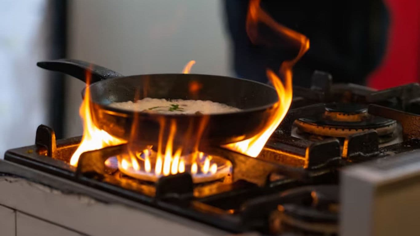 Flaming Pan on Gas Stove in Kitchen