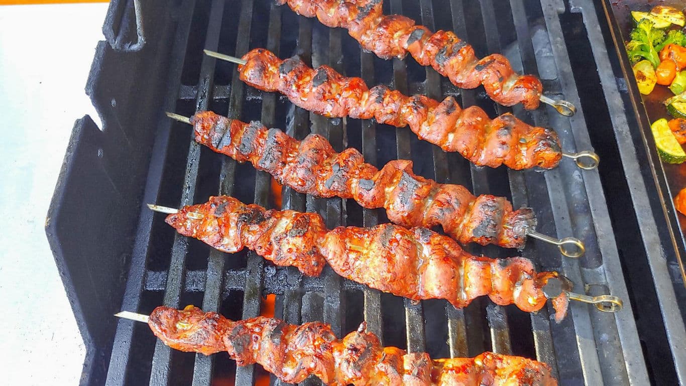 Grilled meat skewers on barbecue grill