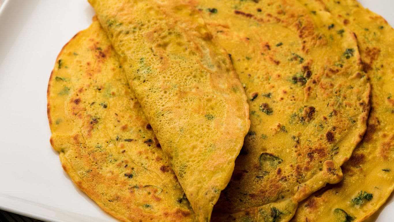 Golden savory pancakes on white plate