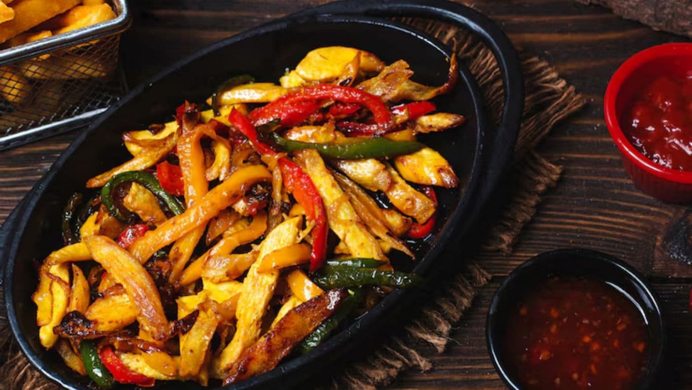 Sizzling vegetable fajitas with sauces