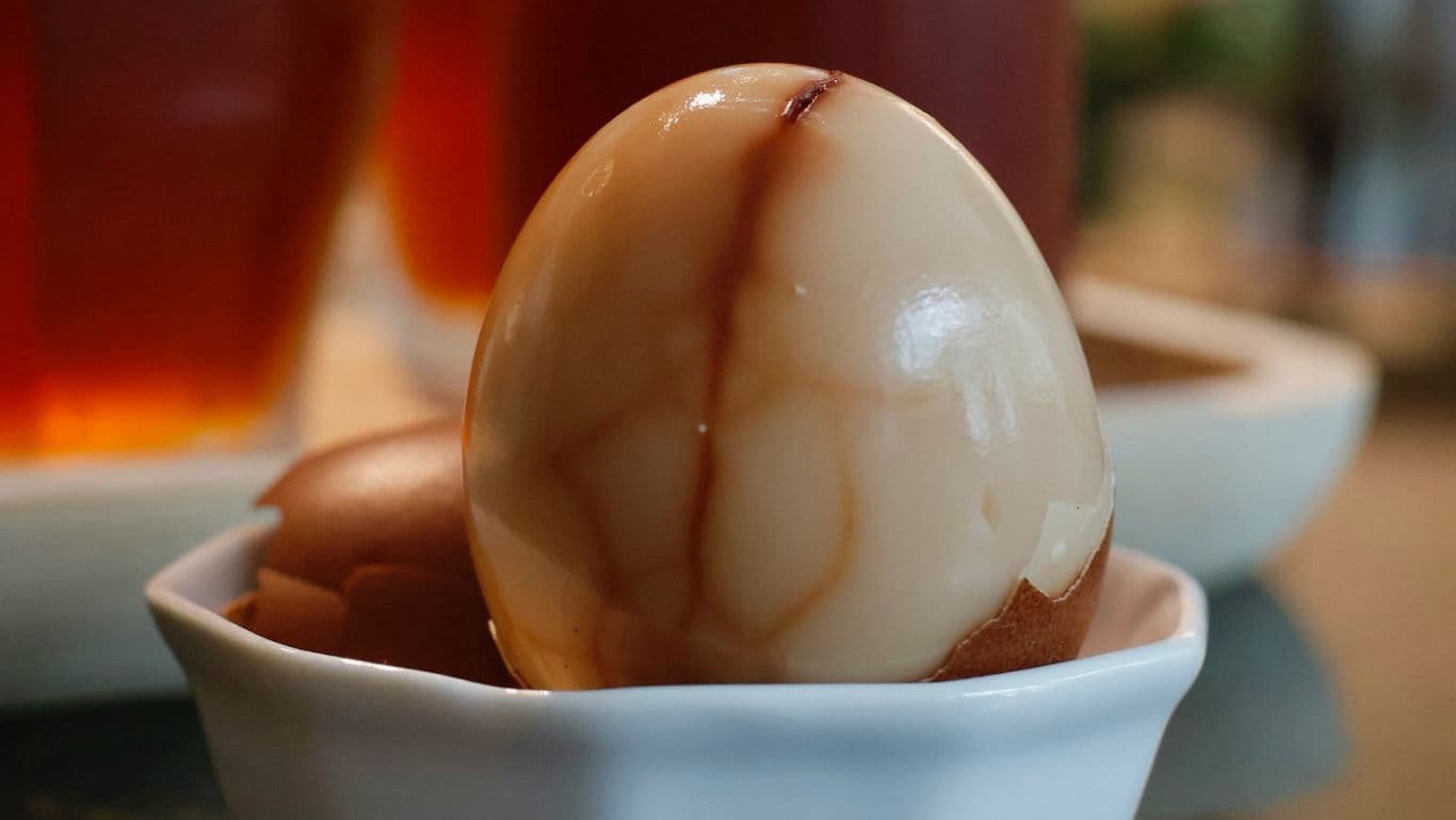 Marbled tea egg in white ceramic dish