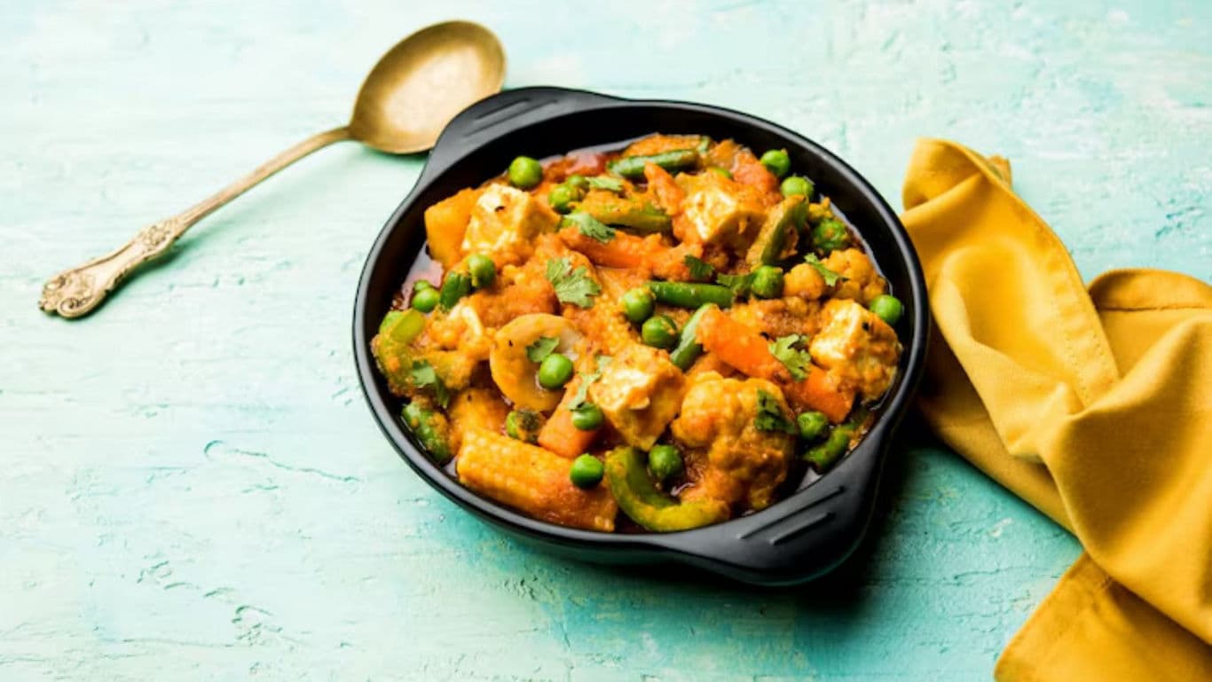 Colorful Indian mixed vegetable curry in black bowl
