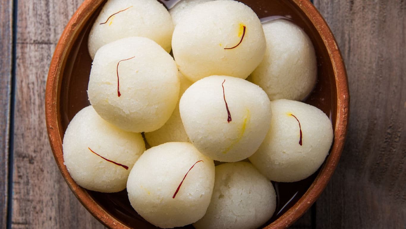 Traditional Indian rasgulla dessert in brown bowl