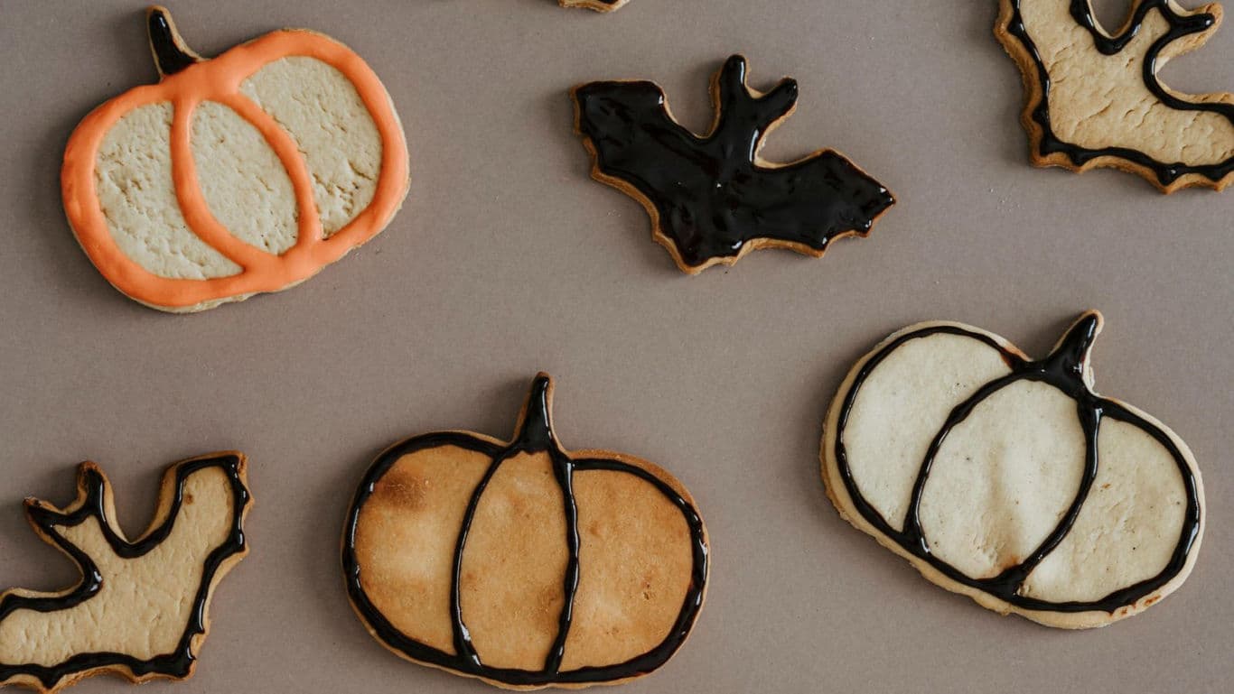 Halloween-themed cookies with pumpkin designs