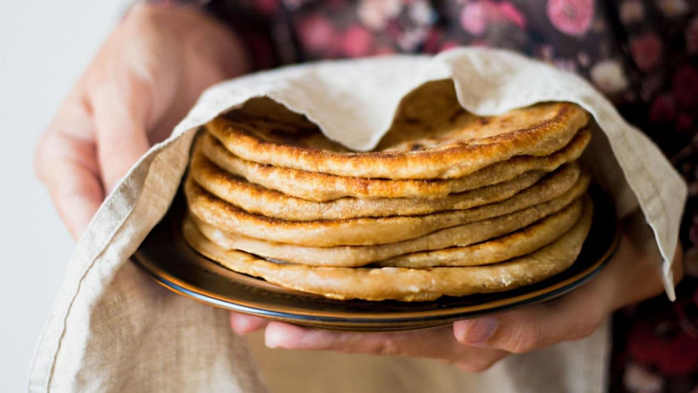 Stack of fresh flatbreads in cloth wrap