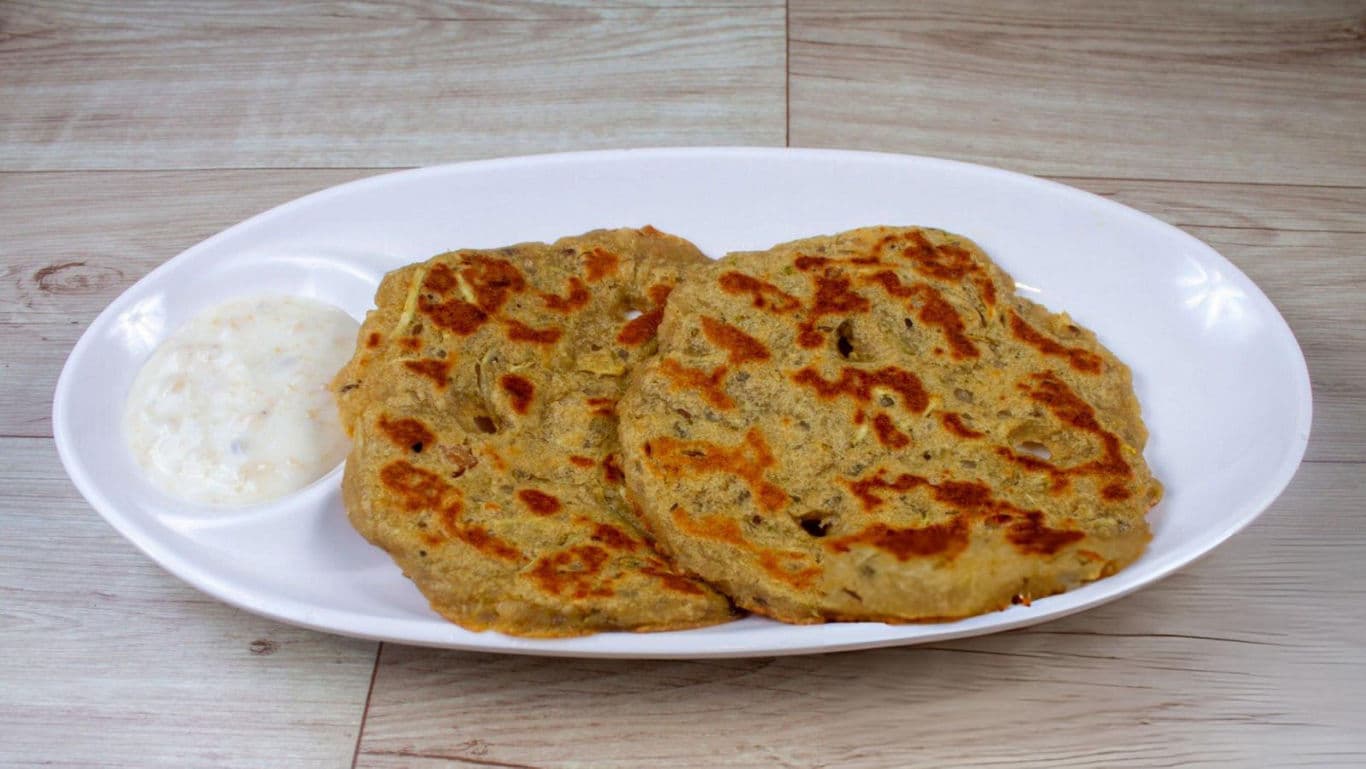 Flatbread with yogurt dip on white plate