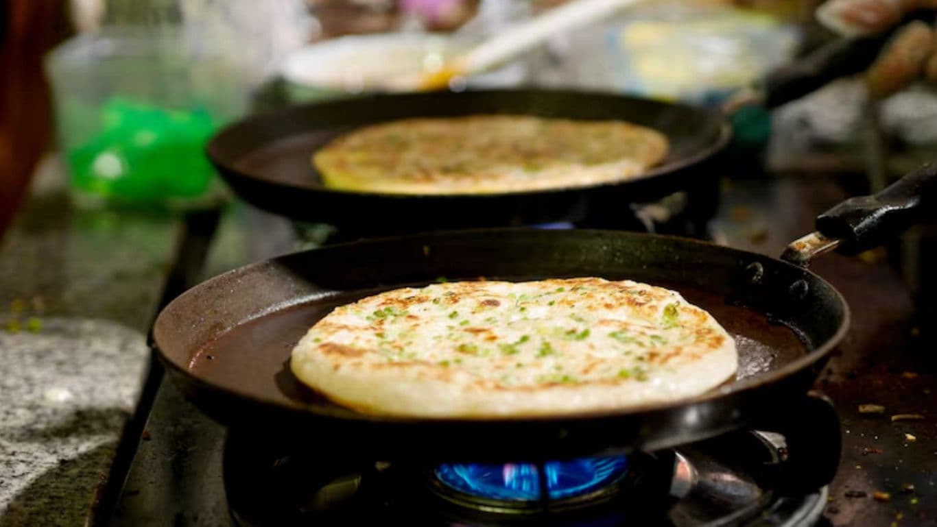 Fresh flatbread cooking on stovetop flame