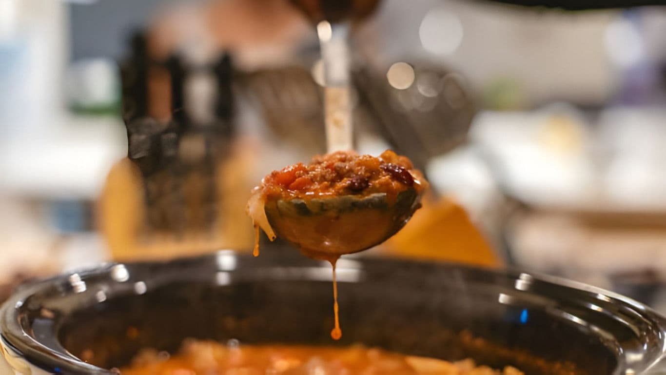 Ladle Serving Hearty Soup From Slow Cooker