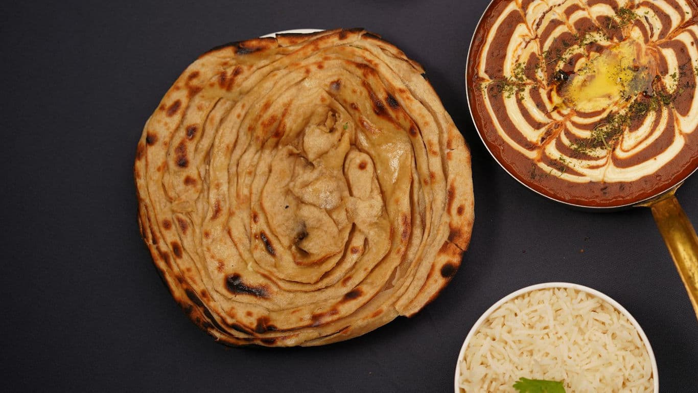 Indian meal with paratha, curry, and rice
