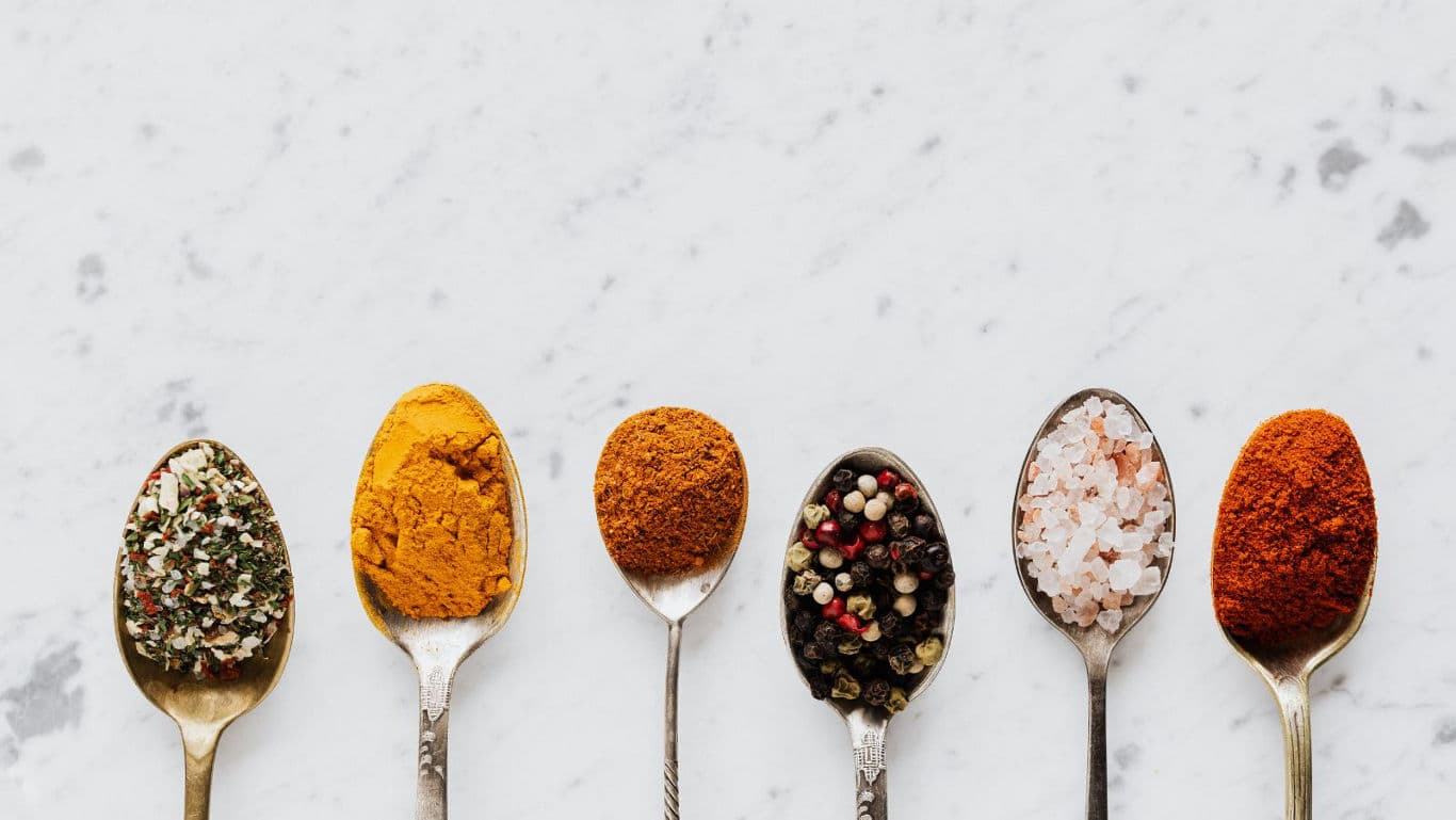 Assorted spices on silver spoons