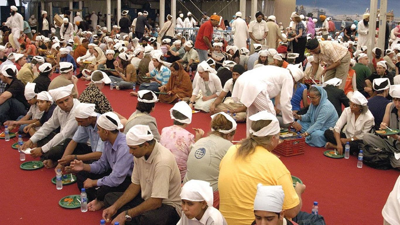 A Sewadaar serving food at Langar