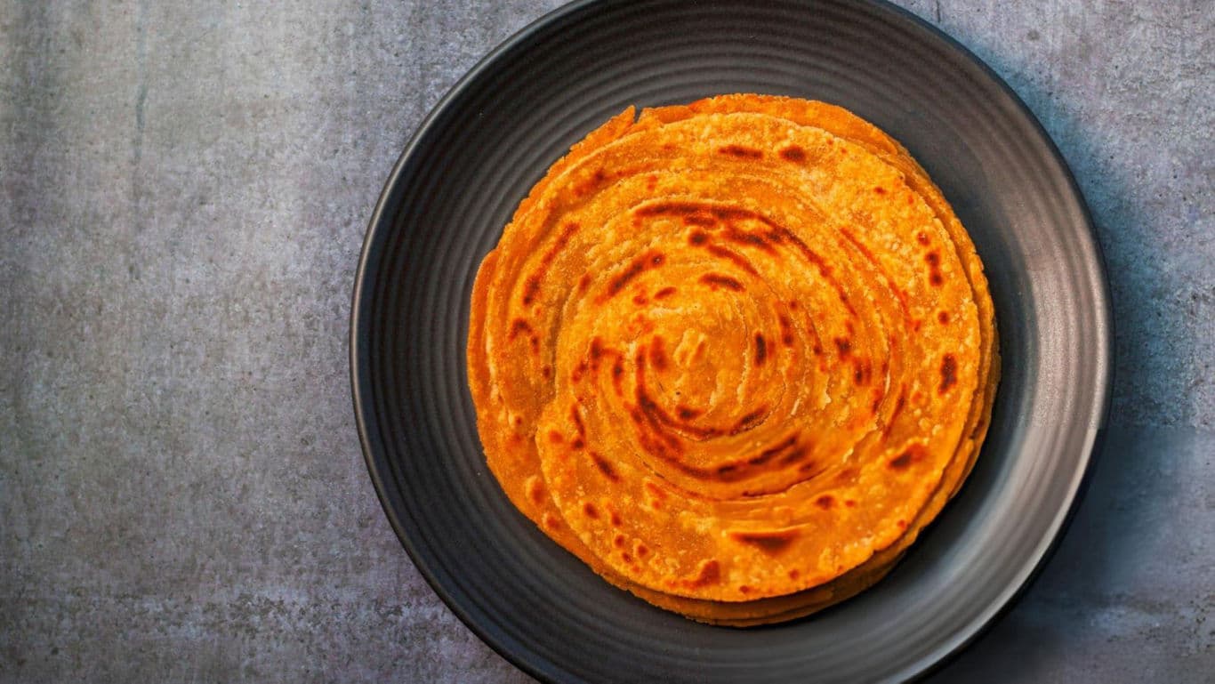 Golden crispy flatbread on dark plate