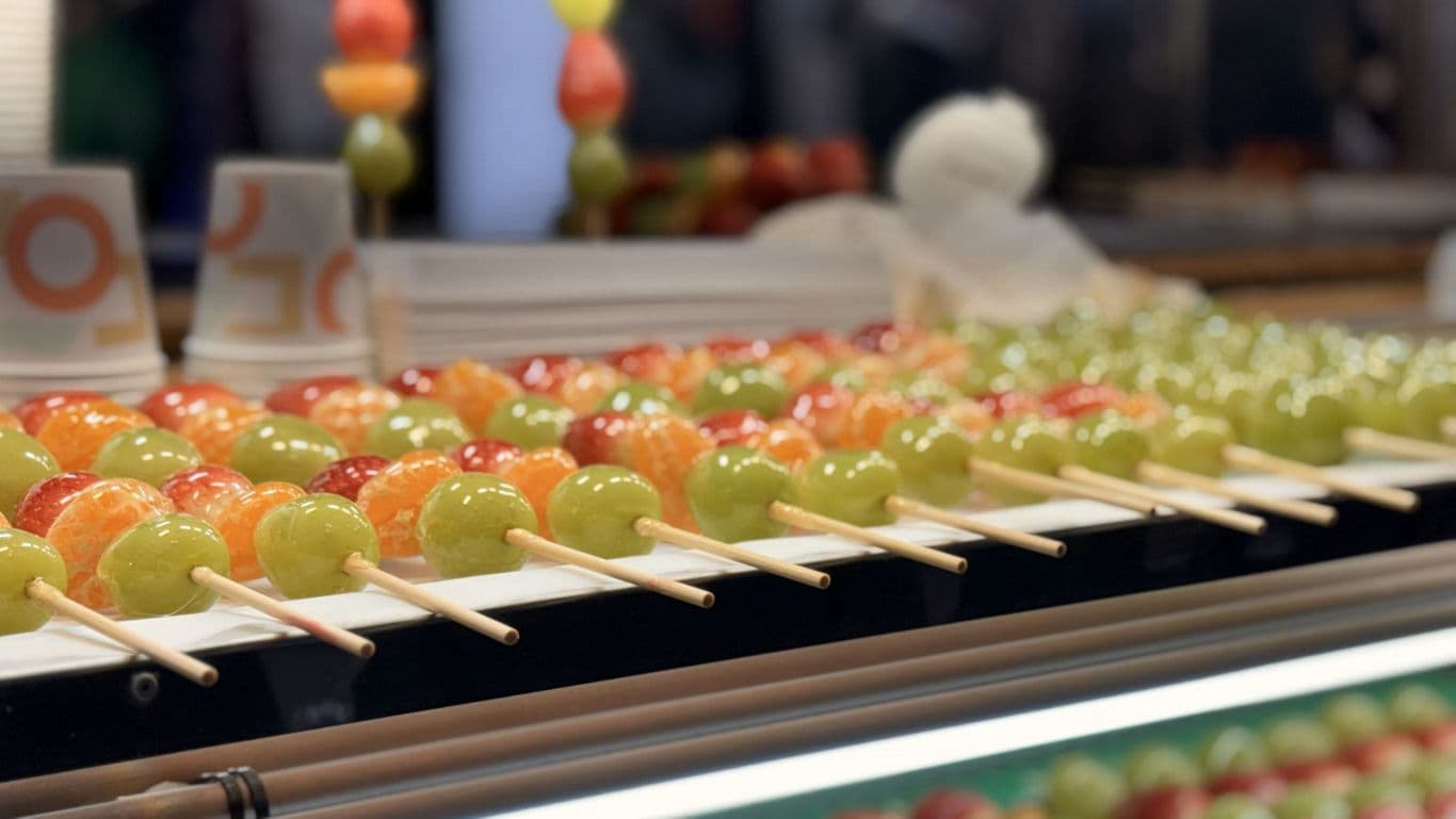 Colorful fruit skewers at food market