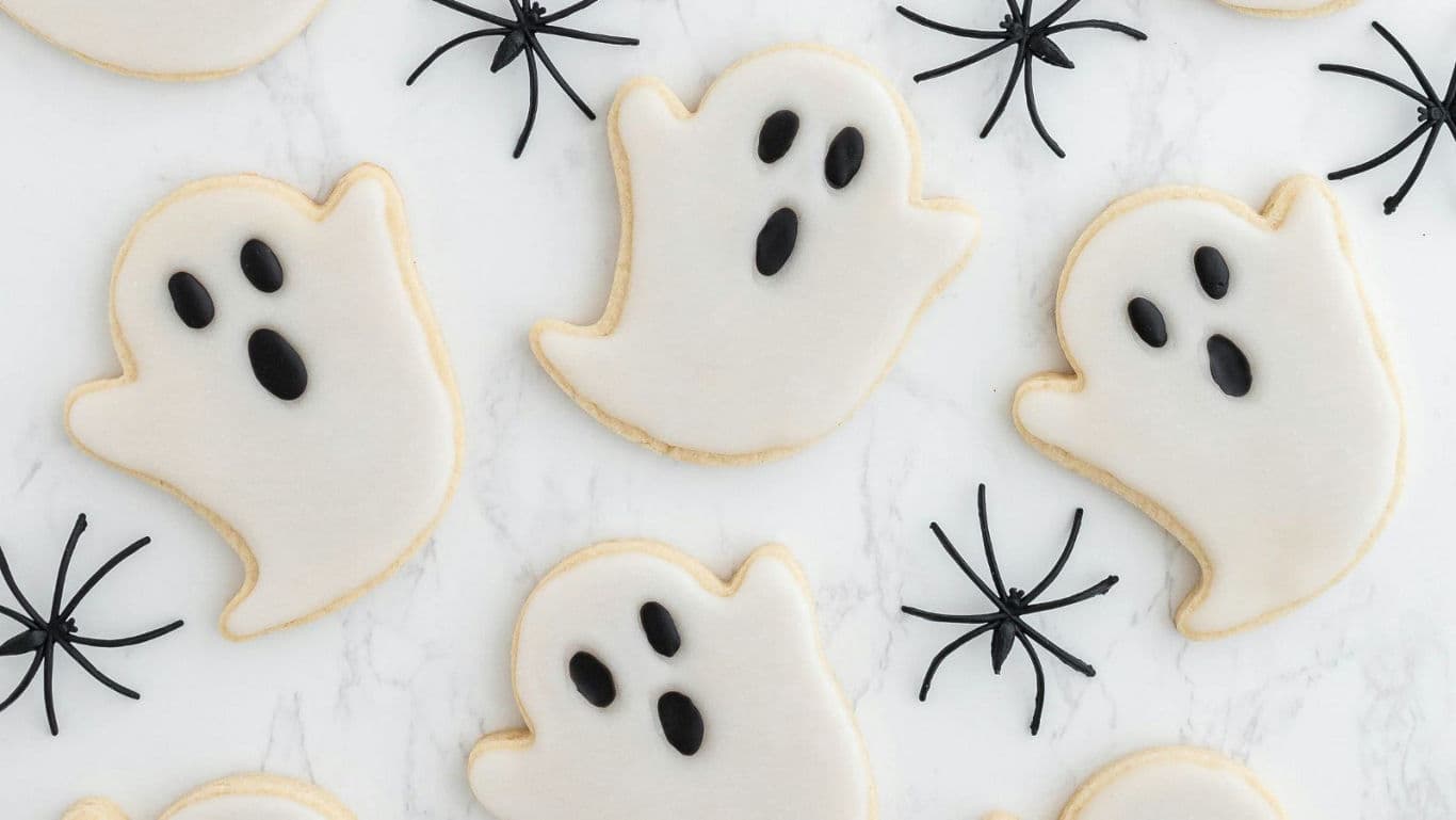 Ghost-shaped cookies with spider accents