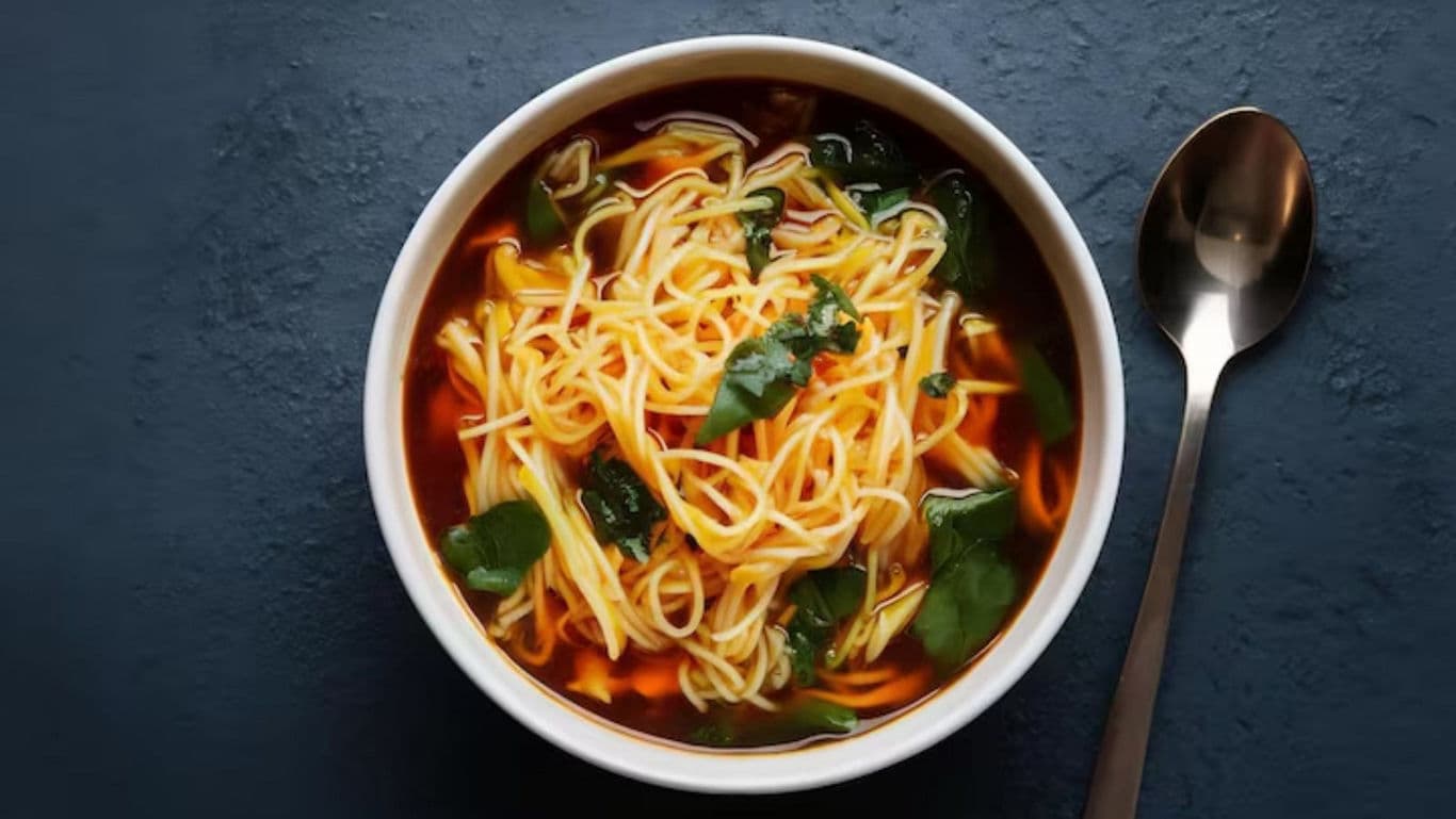 Bowl of noodle soup with herbs