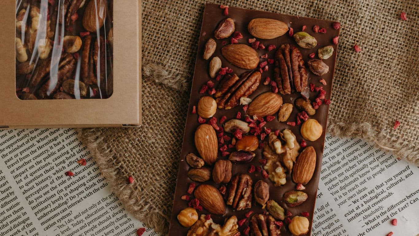 Artisan chocolate bar topped with assorted nuts
