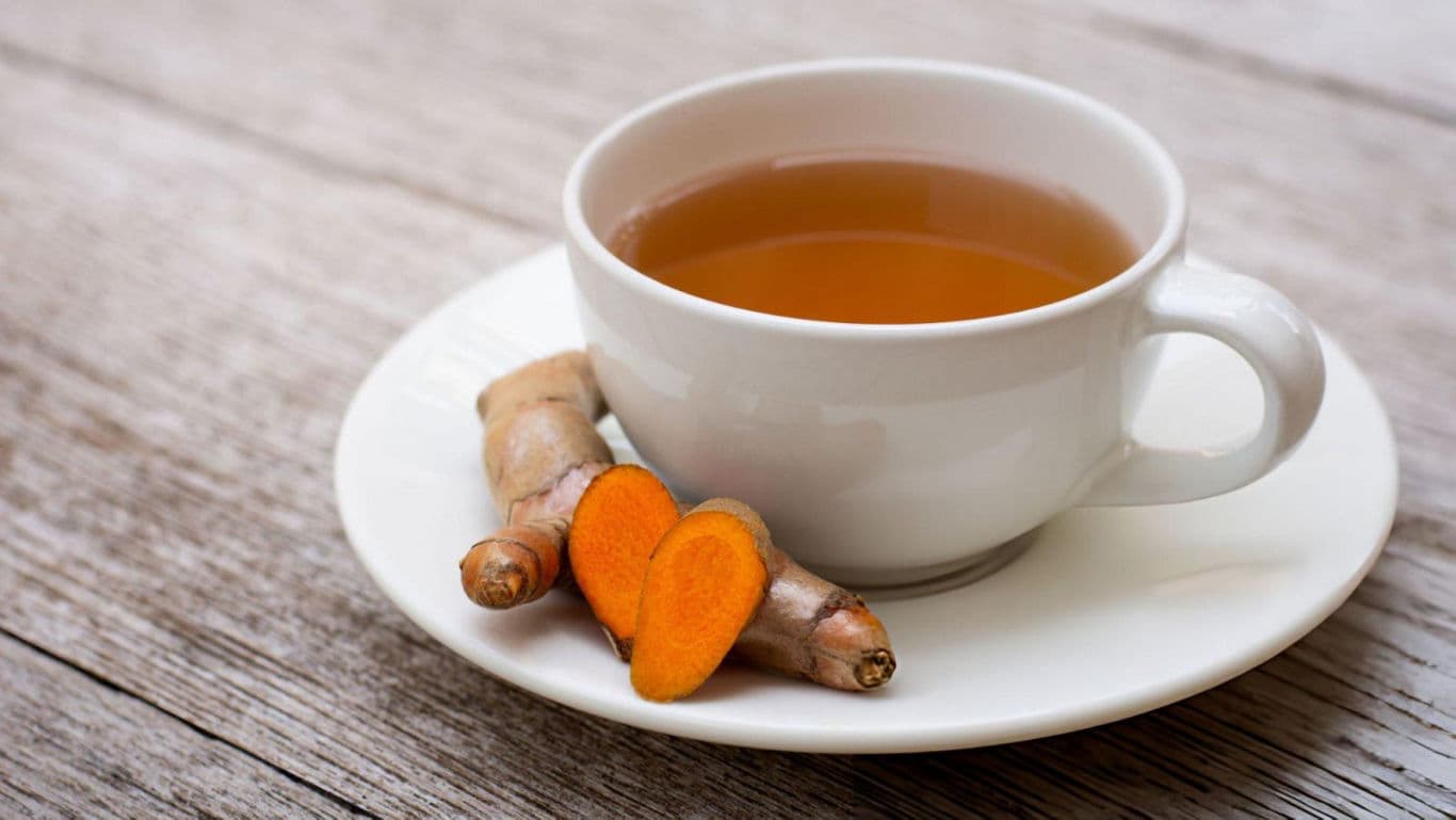 Turmeric tea in white ceramic cup