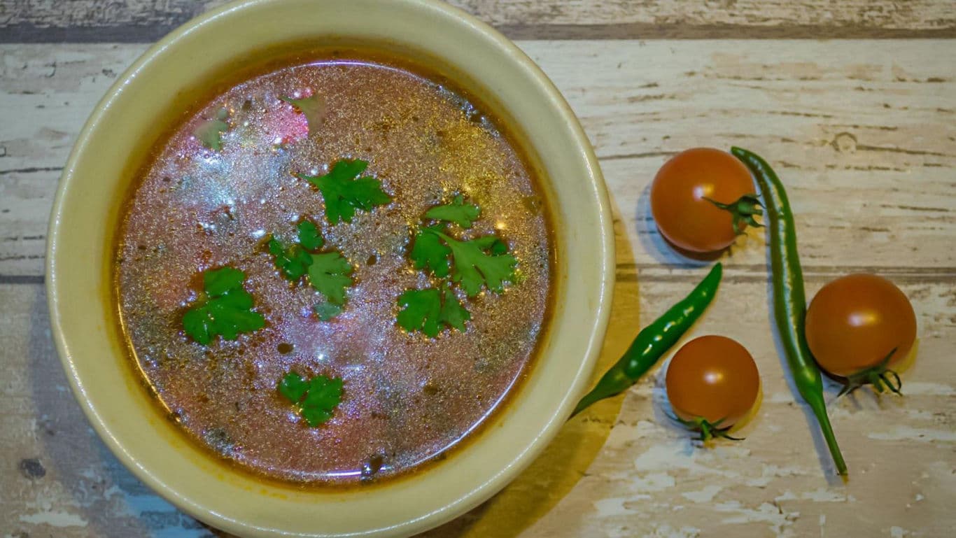 Spicy soup with herbs and fresh vegetables