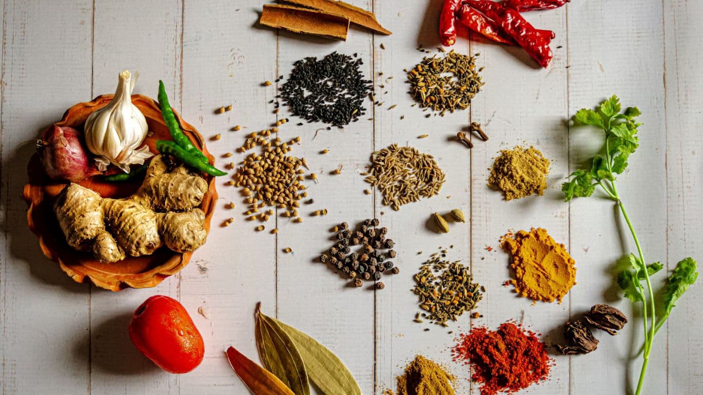Assorted spices and herbs on wooden table