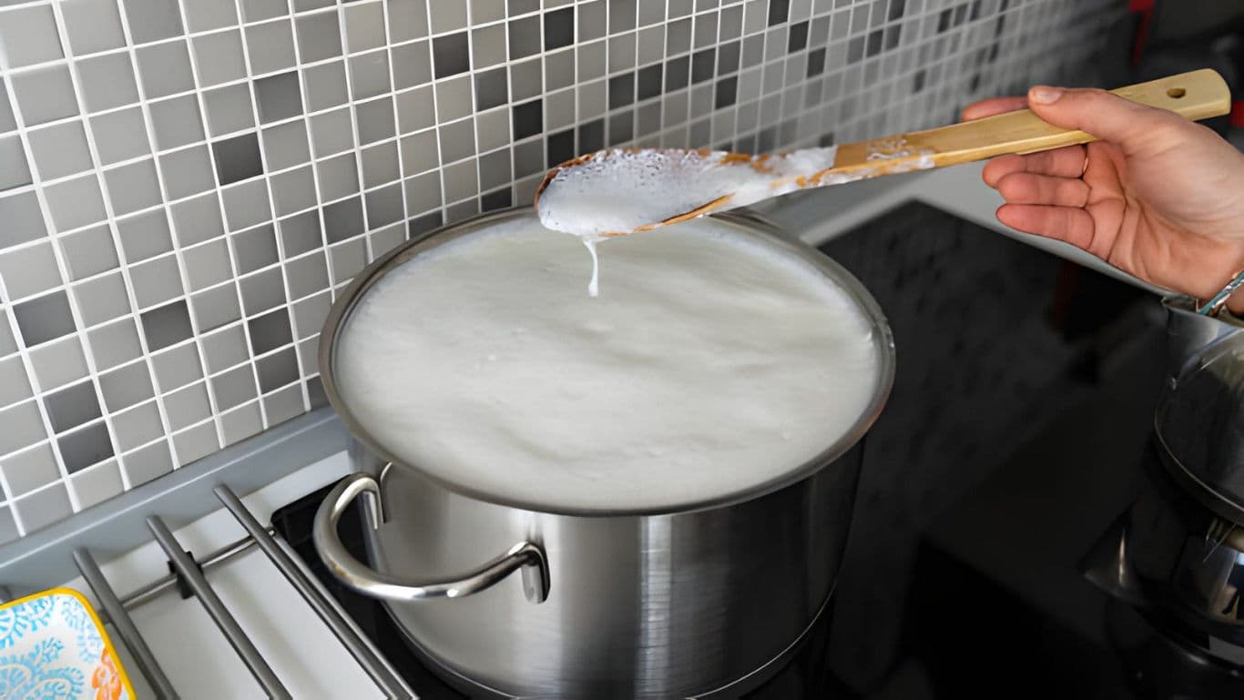 Boiling Milk in Stainless Steel Pot on Stove
