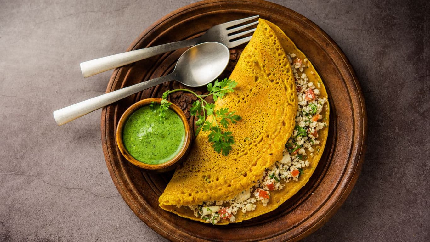 Savory crepe with chutney on wooden plate