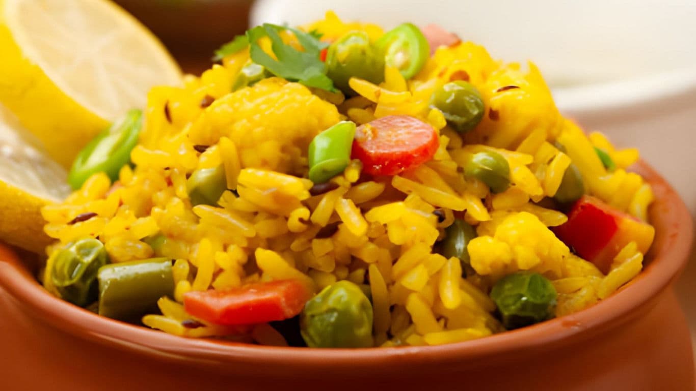 Vibrant vegetable rice dish with lemon garnish