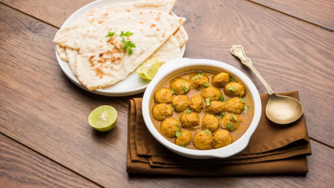 Indian curry with naan and lime garnish