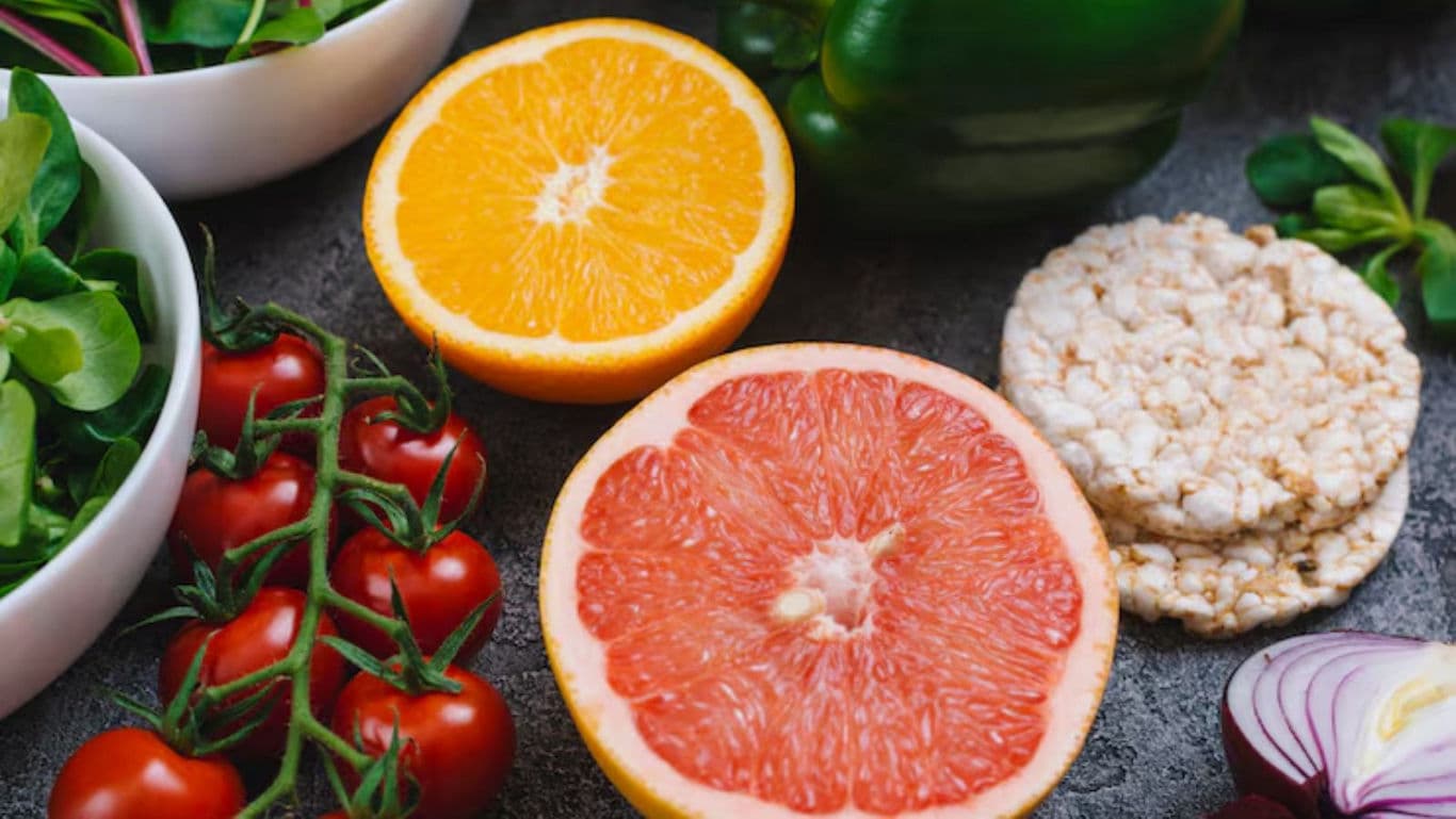 Fresh fruits, vegetables, and rice cakes on table