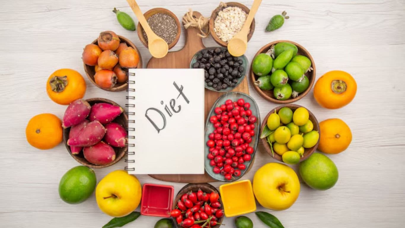 Colorful fruits and diet notebook arrangement