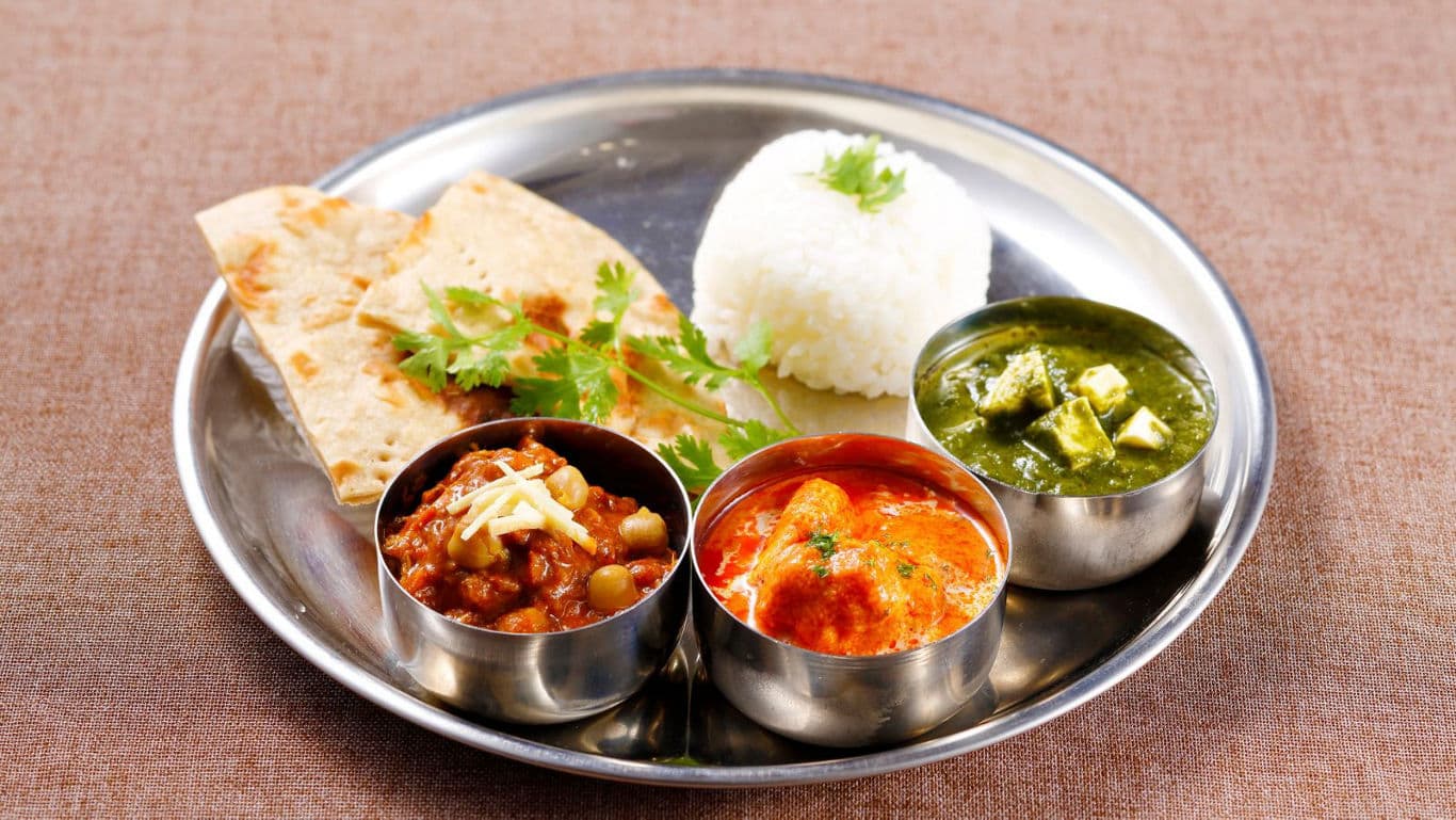 Traditional Indian thali with rice, curry, and bread