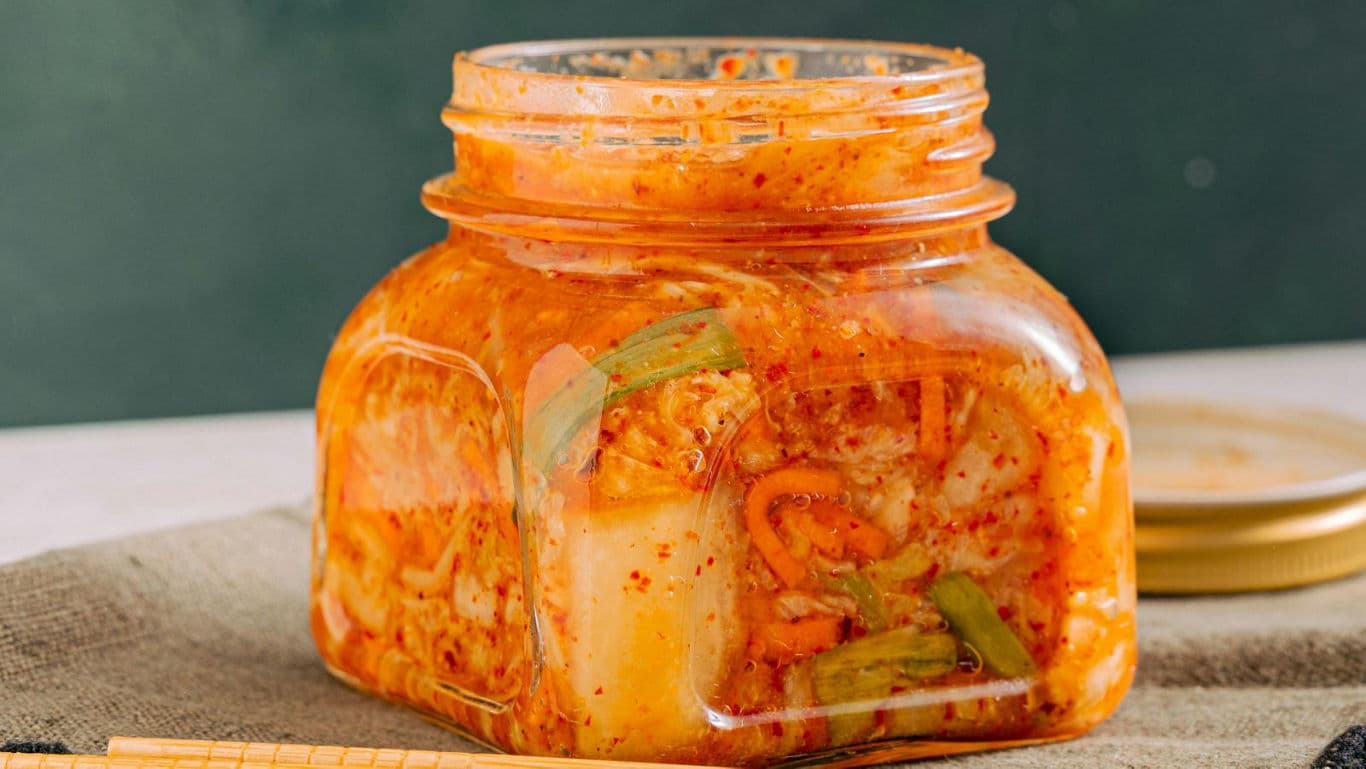 Square glass jar filled with homemade kimchi