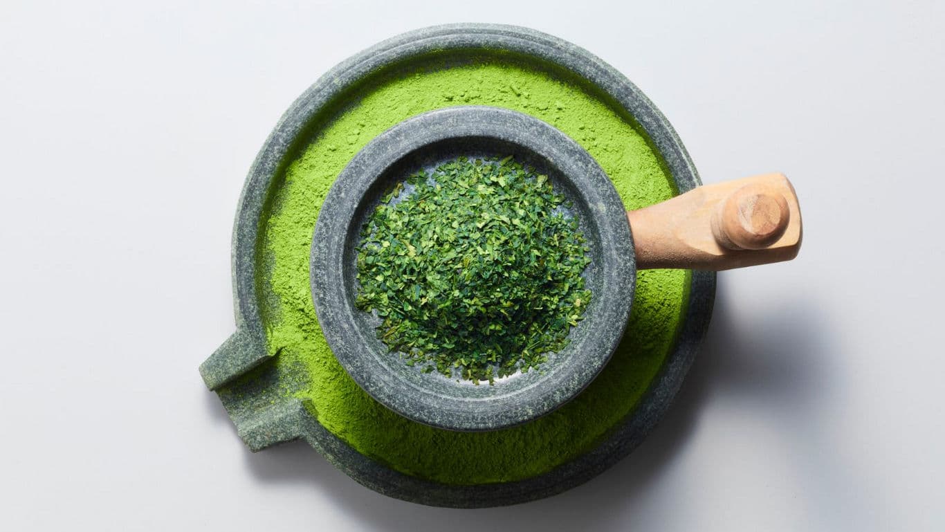Stone Grinder with Green Tea Leaves