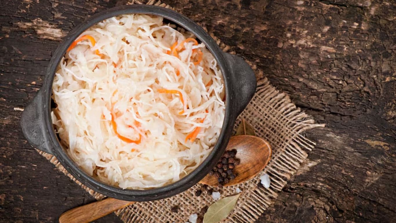 Rustic bowl of homemade sauerkraut on table