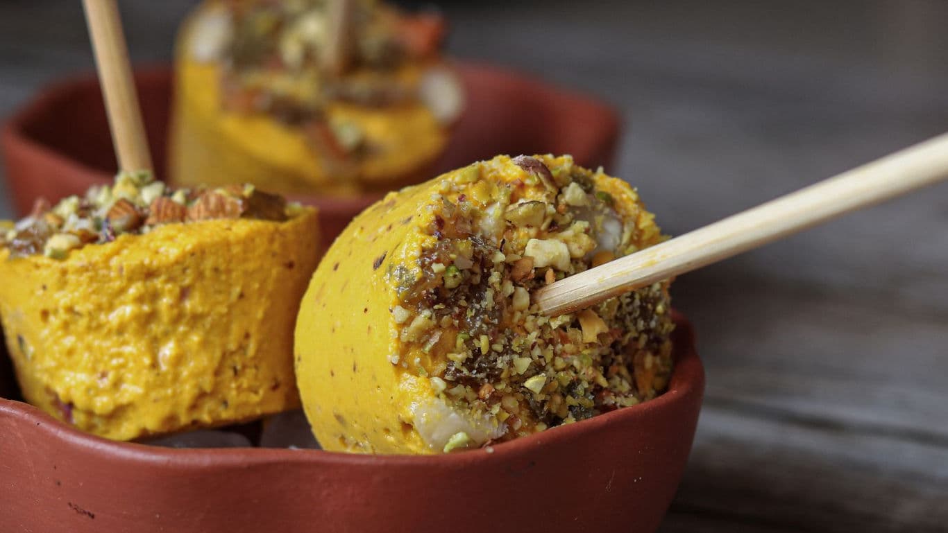Traditional Indian Kulfi with Chopped Nuts on Sticks