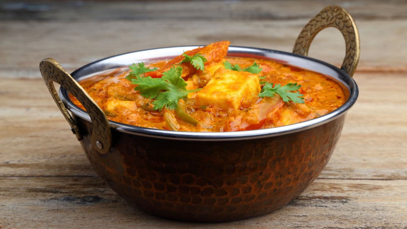 Traditional Indian curry in copper bowl