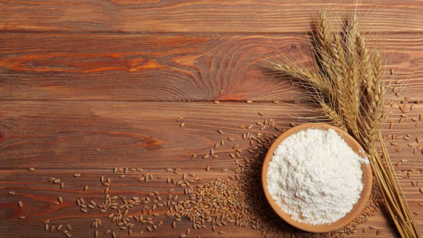 Bowl of flour with wheat grains