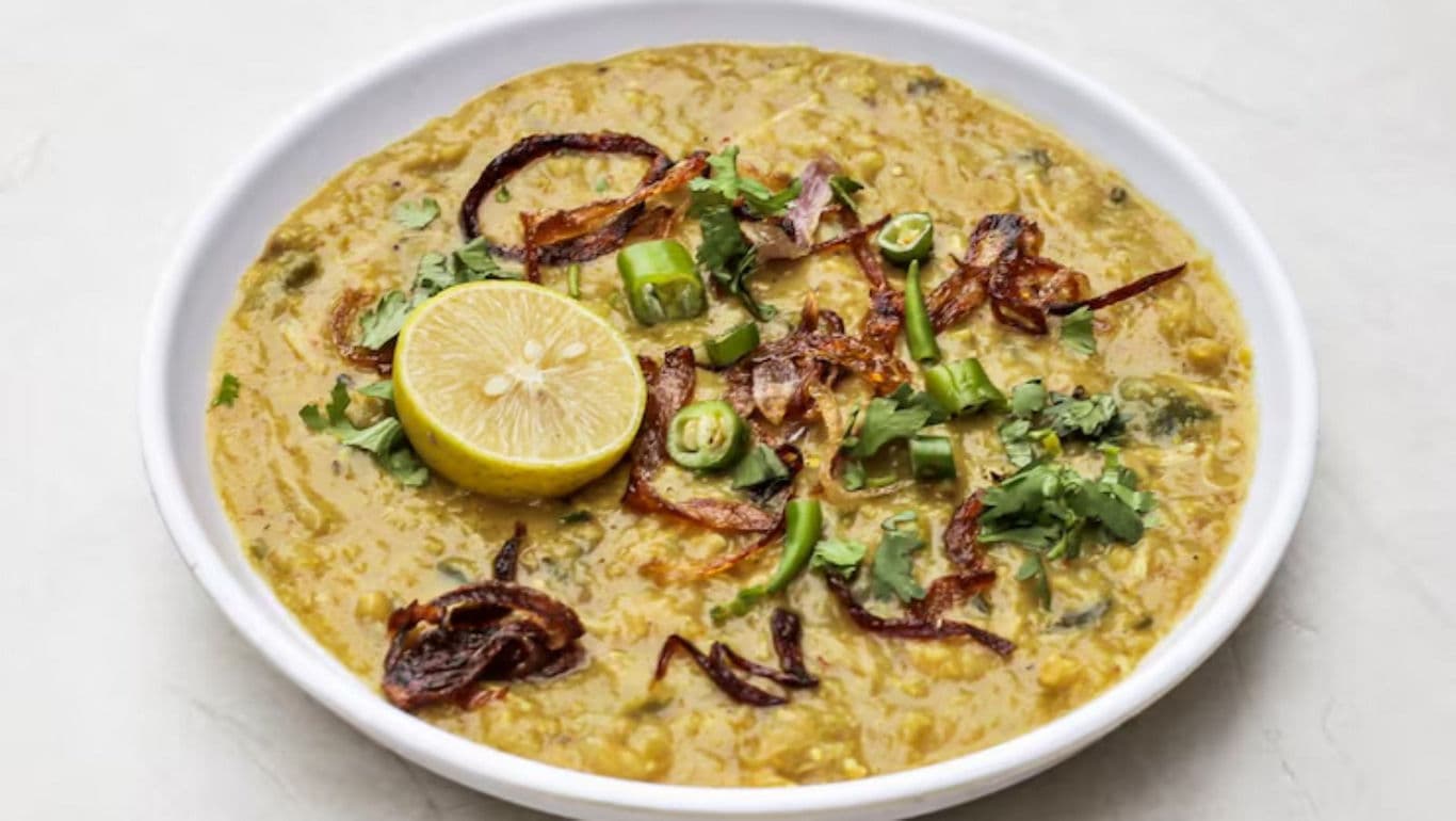 Bowl of lentil curry with garnishes