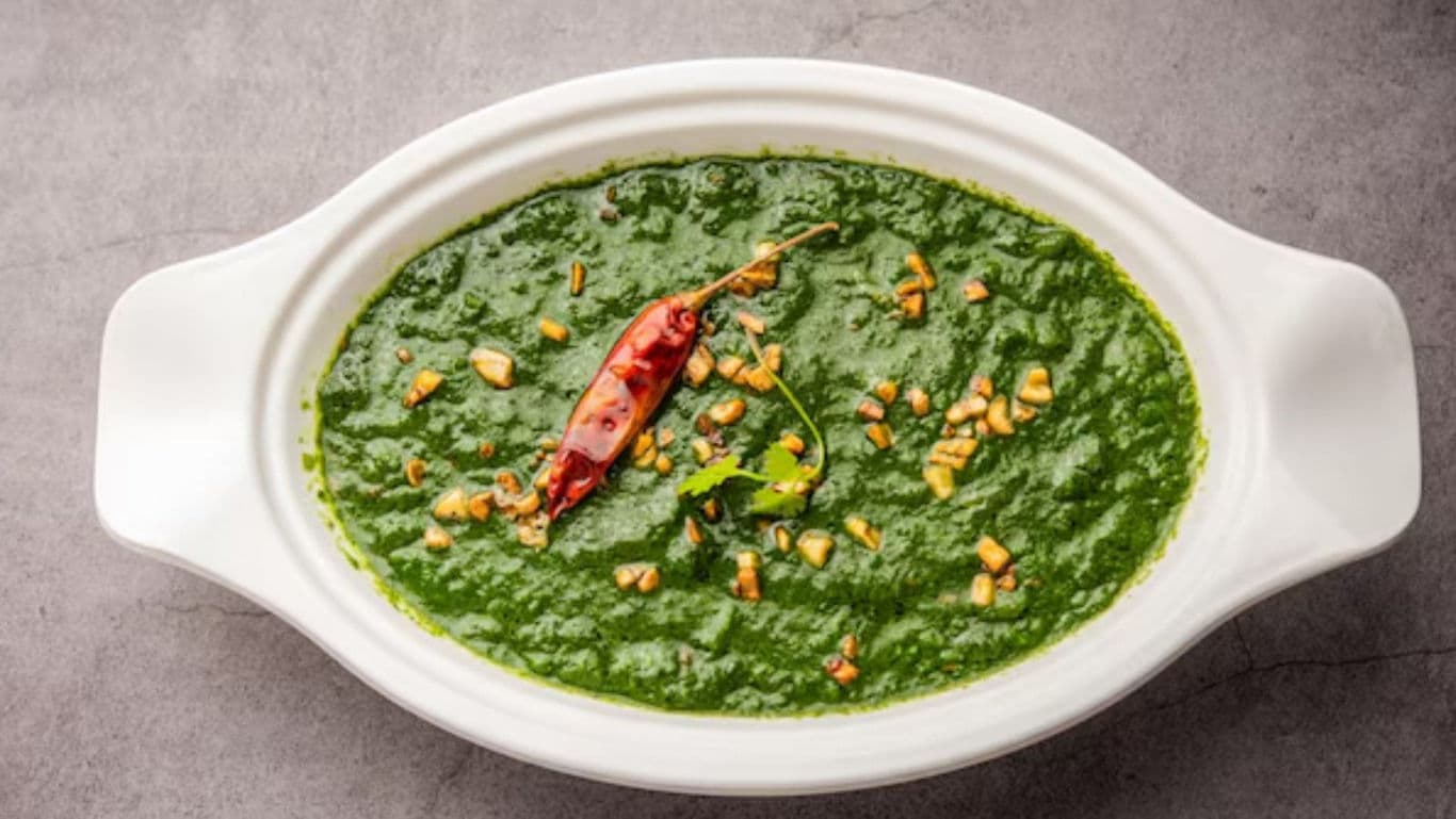 Spinach curry with chili garnish