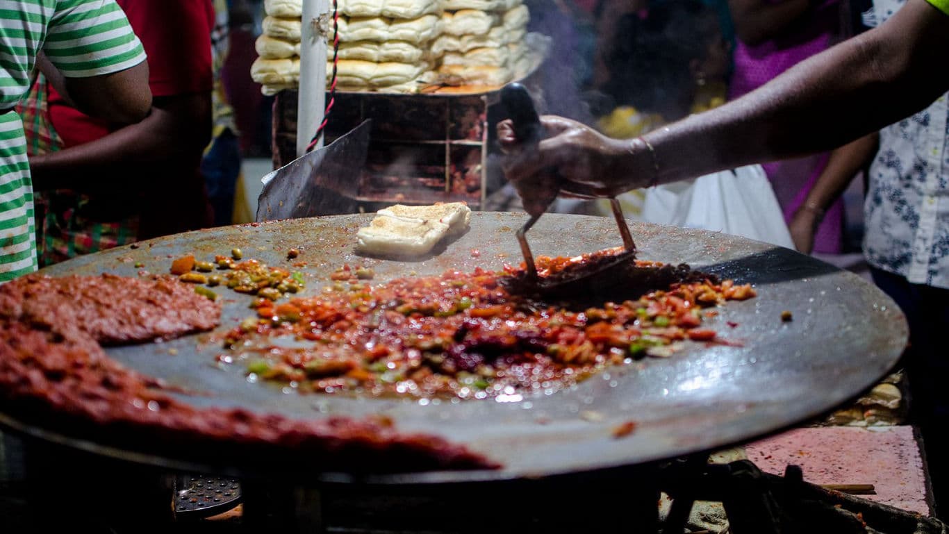 Street food preparation on large griddle