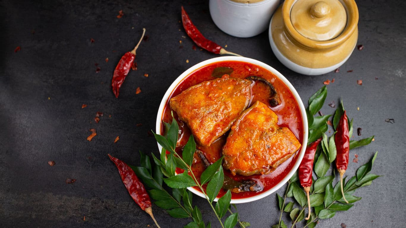 rich fish curry gravy with red chillies
