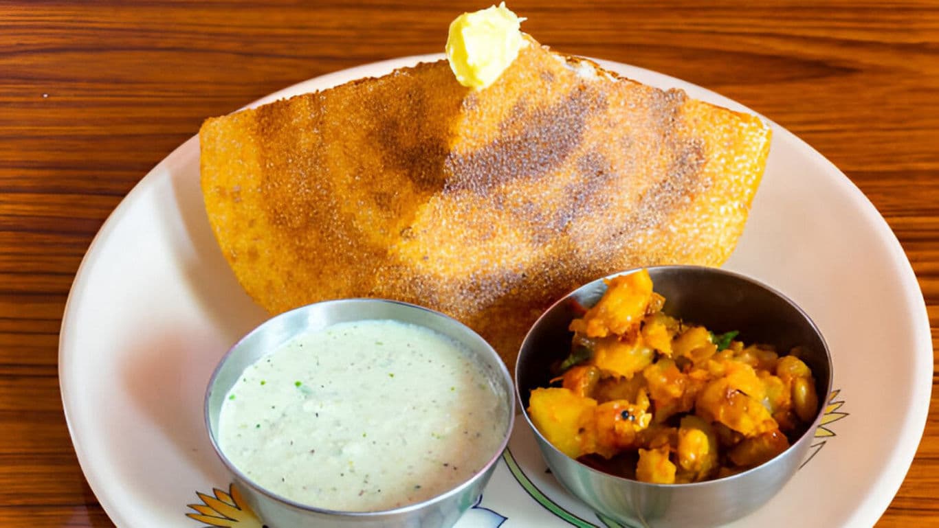 Crispy dosa served with chutney and potato masala