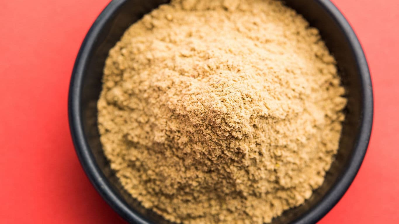 Bowl of Ground Spice on Red Background