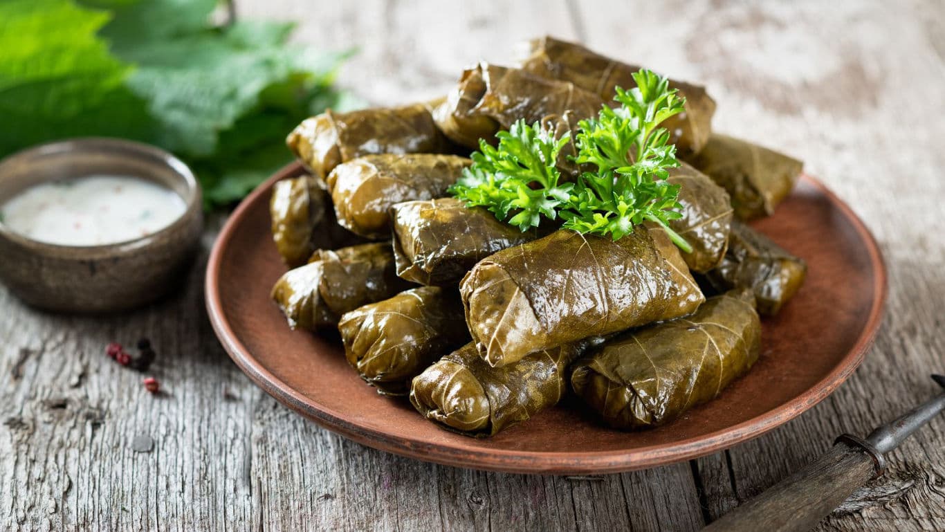 Stuffed grape leaves on rustic plate