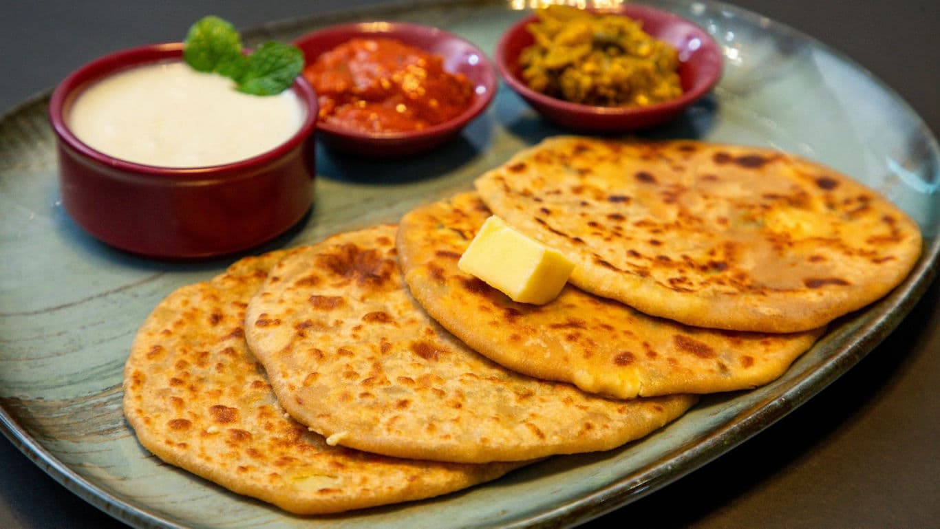 Indian parathas with butter and condiments
